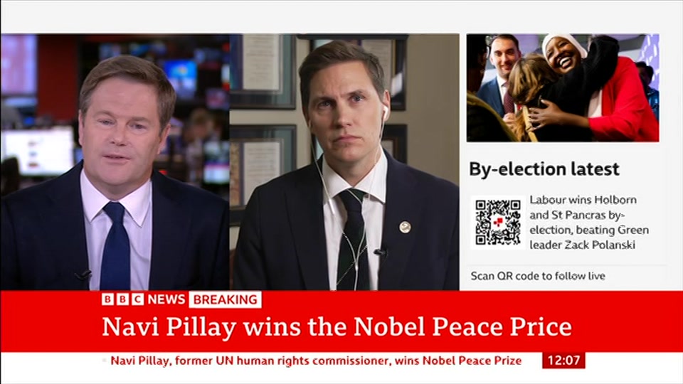 Broadcast still at 7m. BBC News, BBC News Now, 9 October 2026.