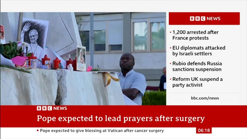 Broadcast still at 18m 30s. BBC News, 18 October 2026.