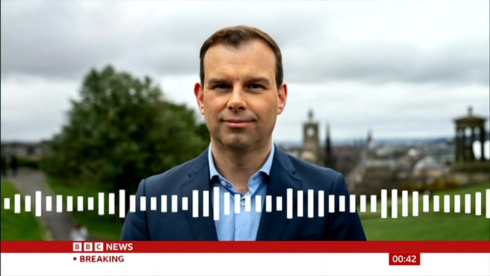 Broadcast still at 12m 30s. BBC News, Newscast, 21 October 2026.